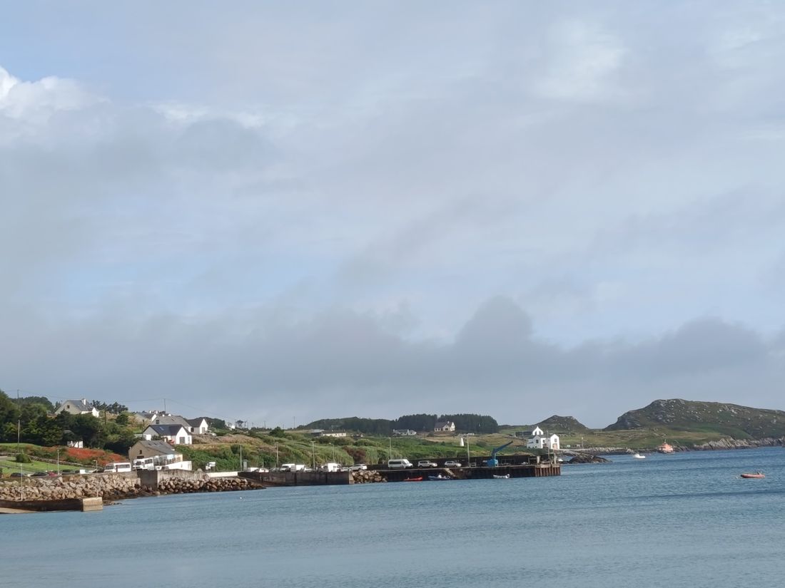 A harbour with white houses and green hills