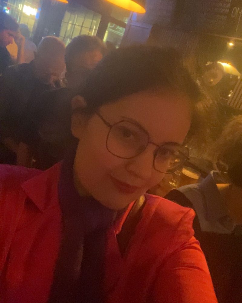 Ella in a red blazer at a deep tech event in Berlin